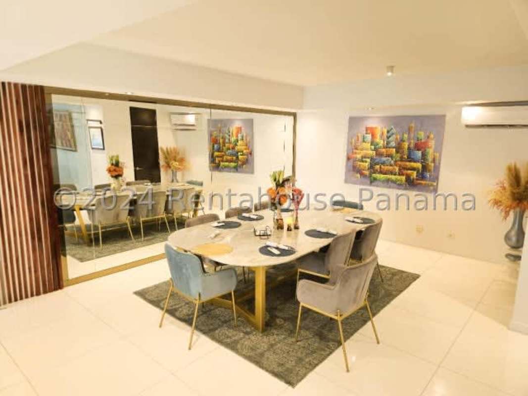 Large dining area with marble table modern lighting artwork in Altos del Golf Panama