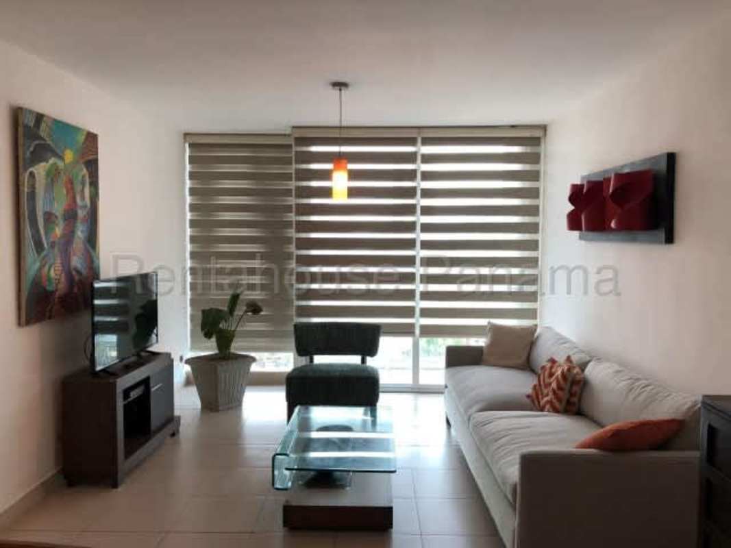 Bright furnished living room with large window at PH Met 1 San Francisco Panama