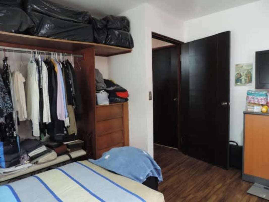 Remodeled kitchen with granite countertop, dark cabinets, stainless steel stove in Villa de las Fuentes house Panama