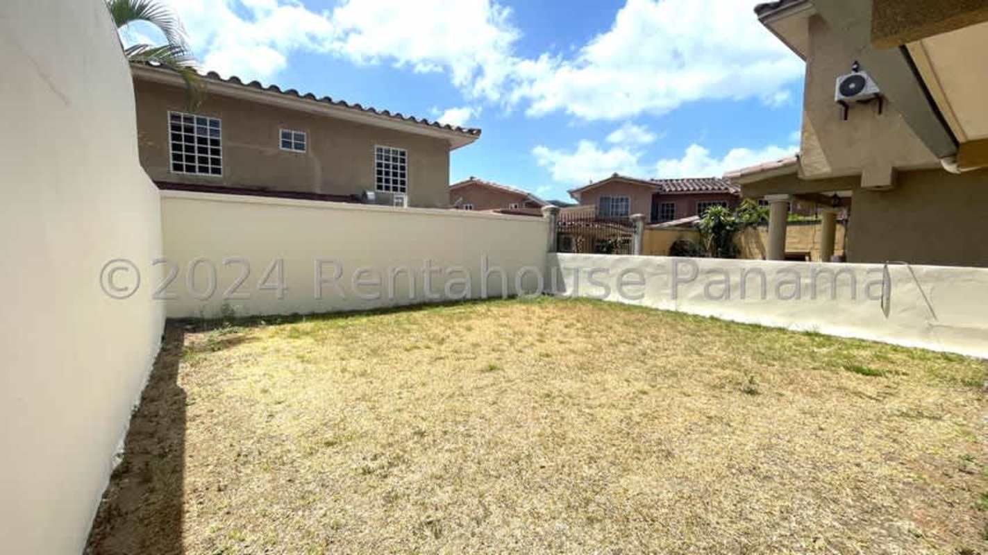 Mediterranean-inspired house with covered terrace, columns and tiled roof in gated Dorado Lakes Panama City