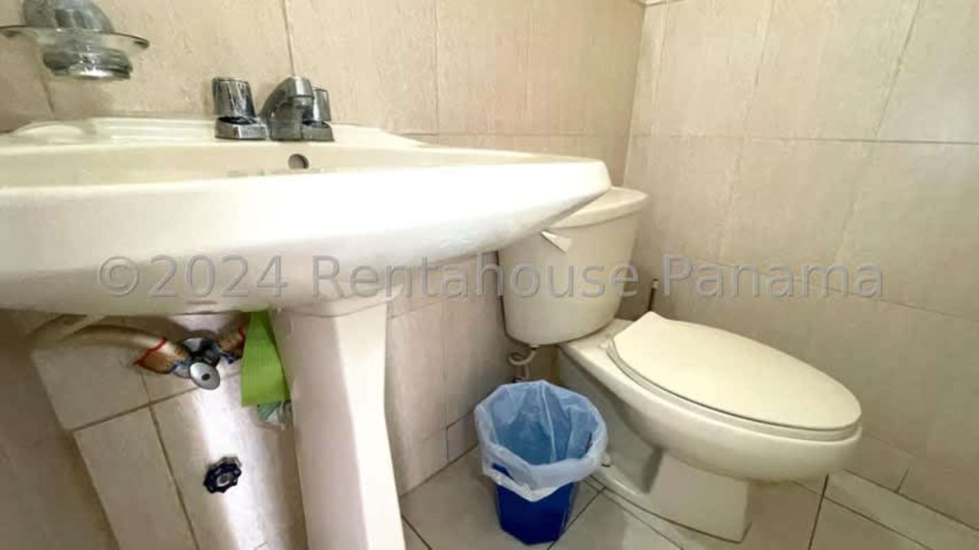 Sunny minimalist bedroom with large window, blinds and tiled floor in Condado del Rey Panama