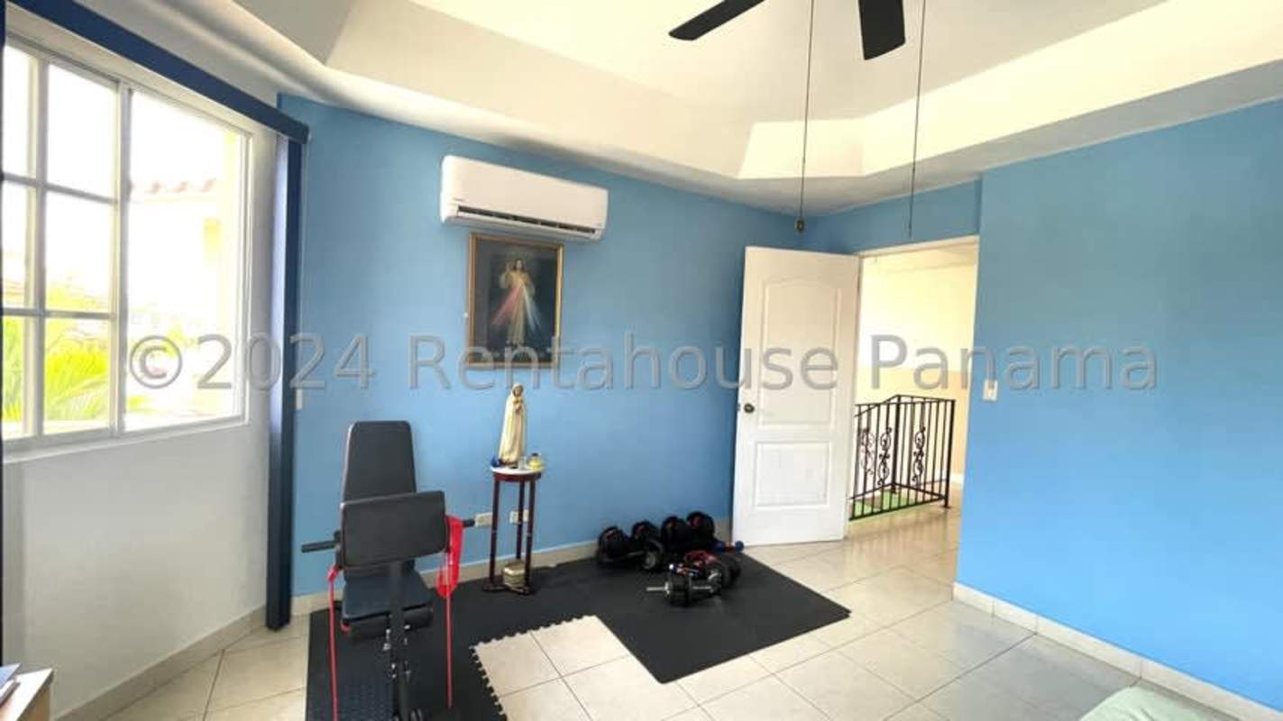 Second bathroom with beige tiles, black and white shower curtain, vanity cabinet in Dorado Lakes Condado del Rey