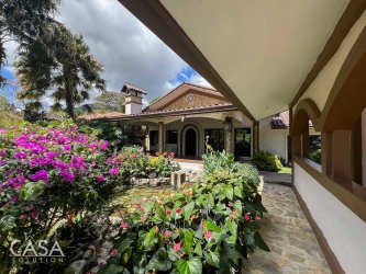 Living room with vaulted wood beam ceiling, fireplace, spacious open area in Panamonte Estates Boquete