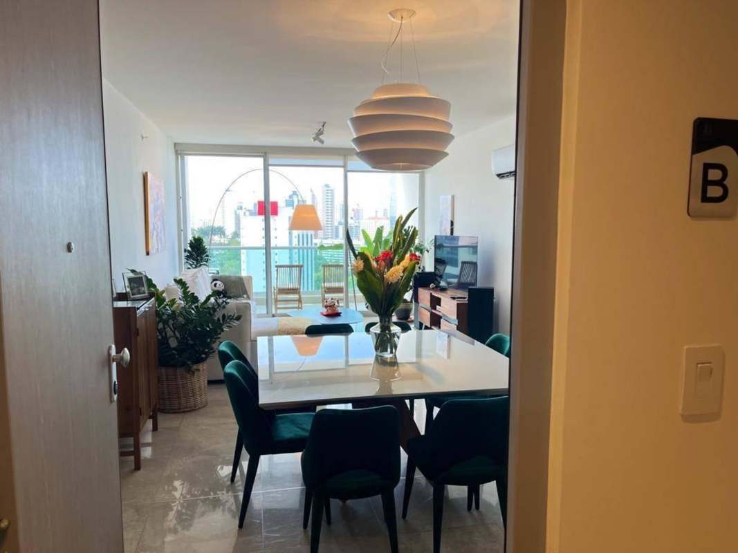 Living room with panoramic bay views and open dining area in PH Costanera Panama