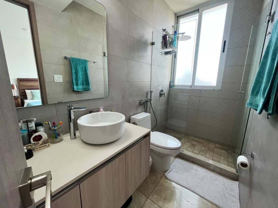 Bedroom with large window overlooking city, furnished in PH Costanera Panama