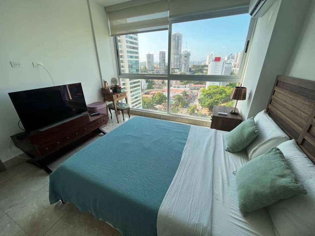 Bedroom with TV console, city view, and large window in PH Costanera