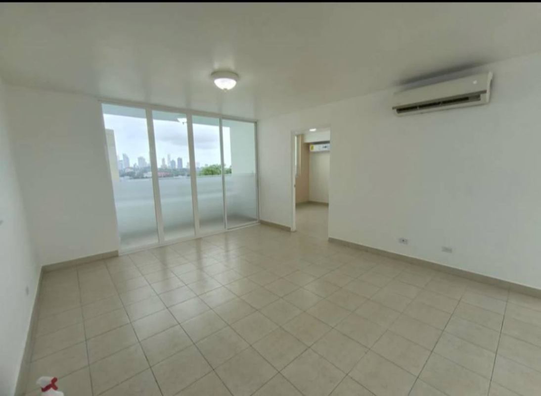 Modern living room with large windows balcony access and tile floors overlooking Panama City