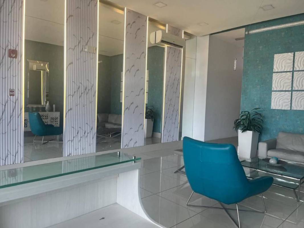 Modern decorated lobby with blue accent walls at Torres de Castilla condominium in Panama