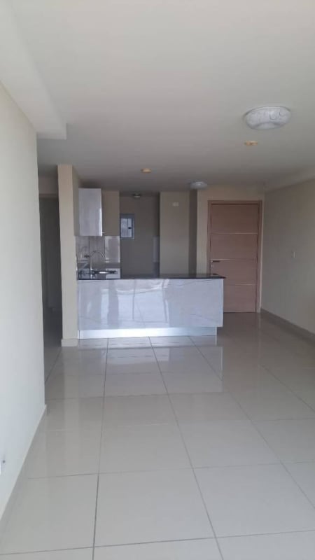 Open living room and kitchen with tile floors at PH Torres de Castilla Panama City
