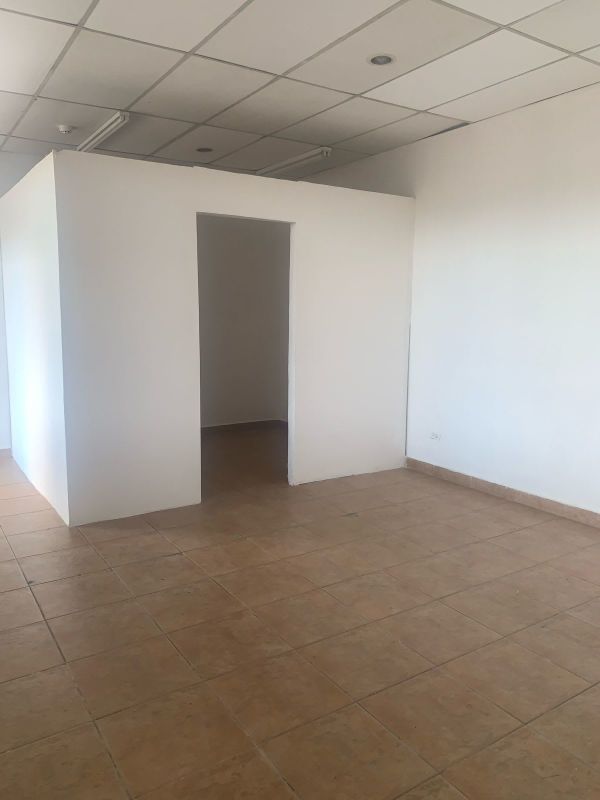 Empty office or retail commercial interior space with tile floor and drop ceiling in Villa de las Fuentes Panama