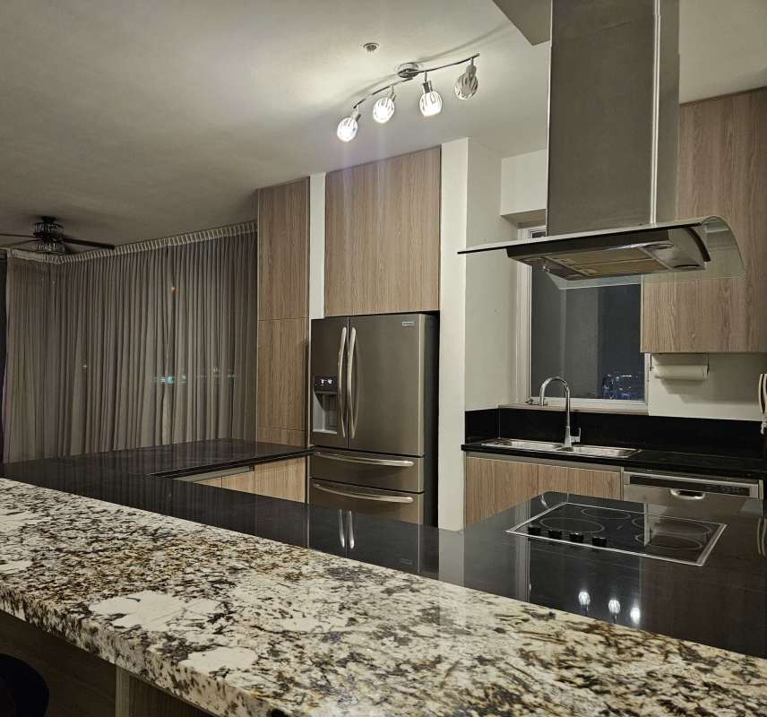 Modern kitchen island, stainless appliances, light wood cabinets, Rivage Tower Panama Oceanview Apartment