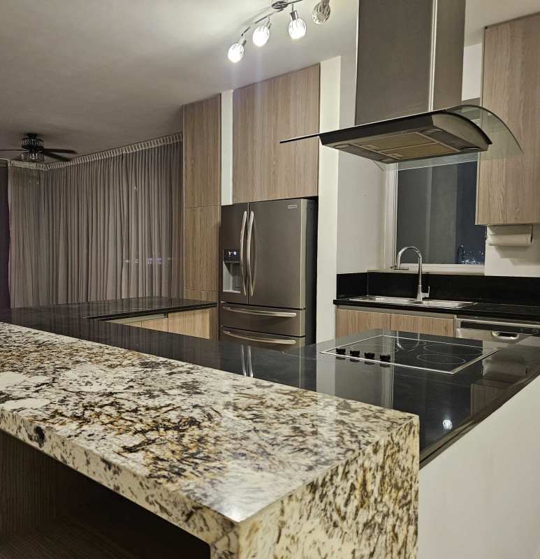 Contemporary kitchen with granite island, black backsplash in oceanview apartment in Rivage Tower Panama