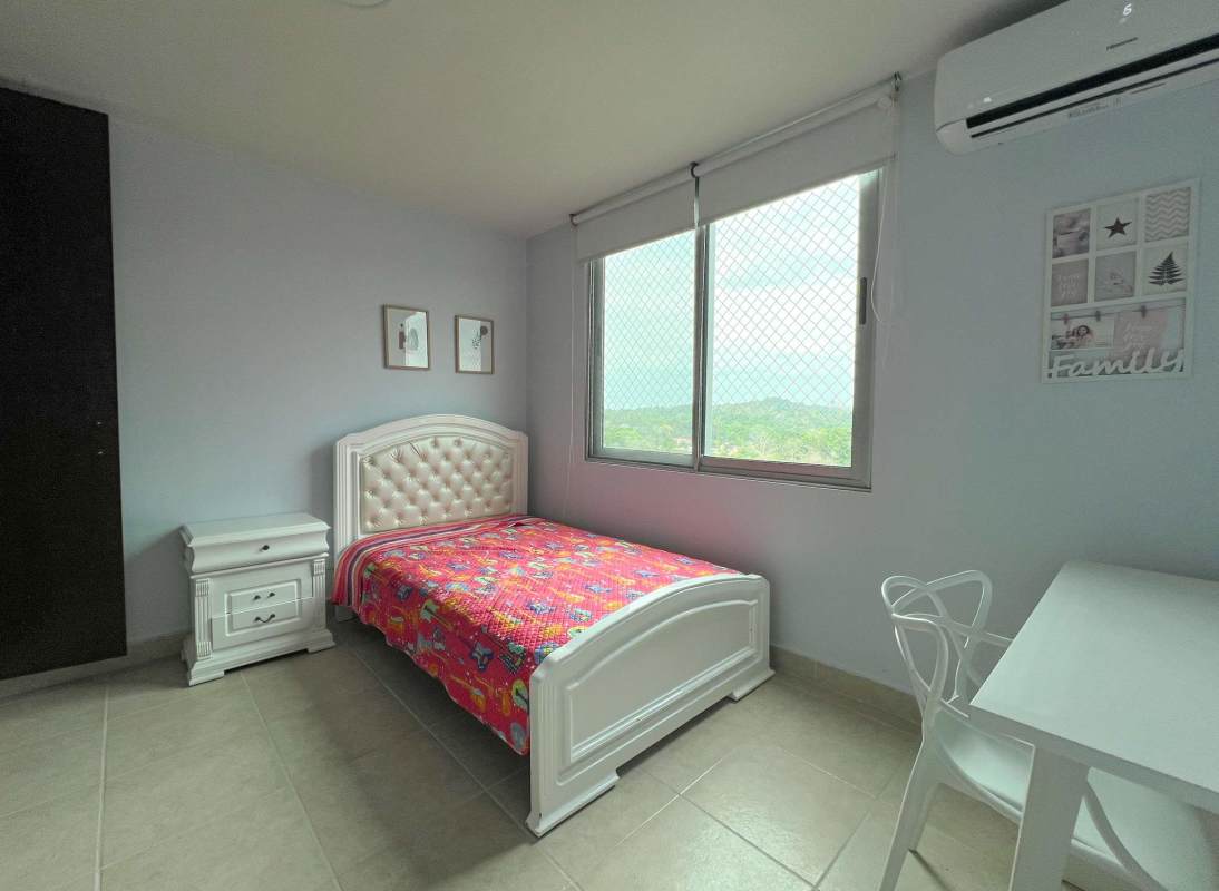 Kids bedroom with colorful bedspread large window mountain view Clayton Park rental Panama