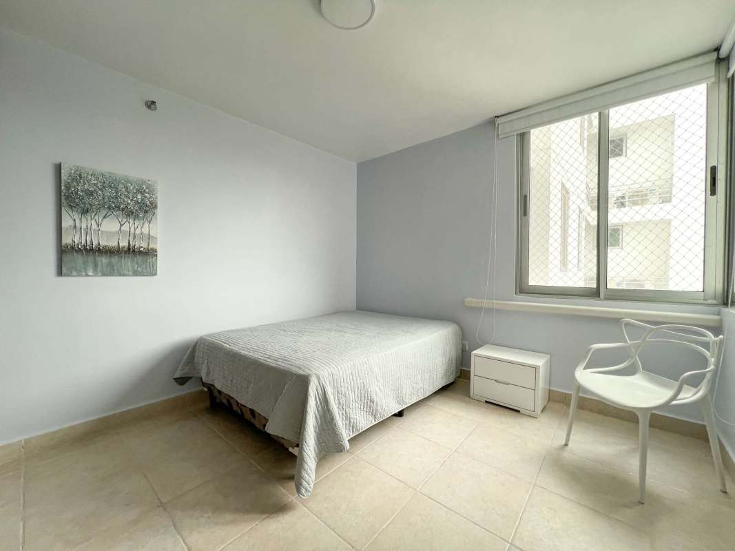 Bedroom with large bed, window, neutral colors in Clayton Park apartment rental Panama