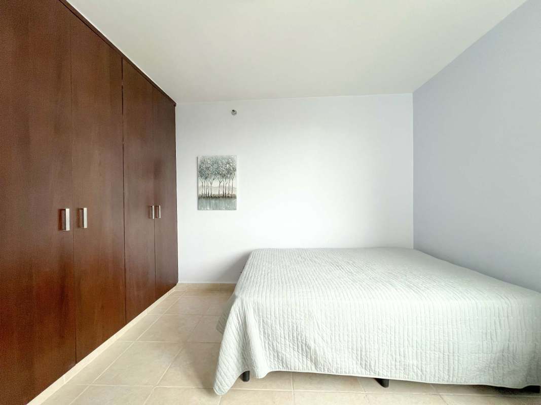Minimalist bedroom with built-in wardrobe tile flooring in Clayton Park apartment Panama