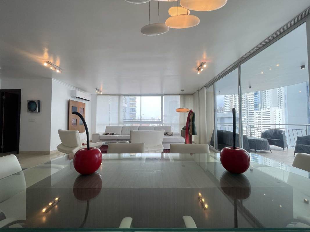 Spacious living and dining area with marble flooring, large floor-to-ceiling windows and sea views at PH Vista del Sol Punta Paitilla