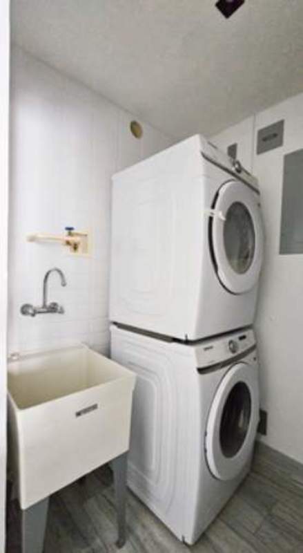 Modern apartment living area with floor-to-ceiling windows and balcony access PH Nuovo by Armani Bella Vista Panama