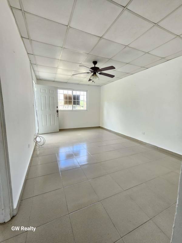 Basic kitchen white cabinets brown countertop tile backsplash Arch Praderas San Lorenzo Panama