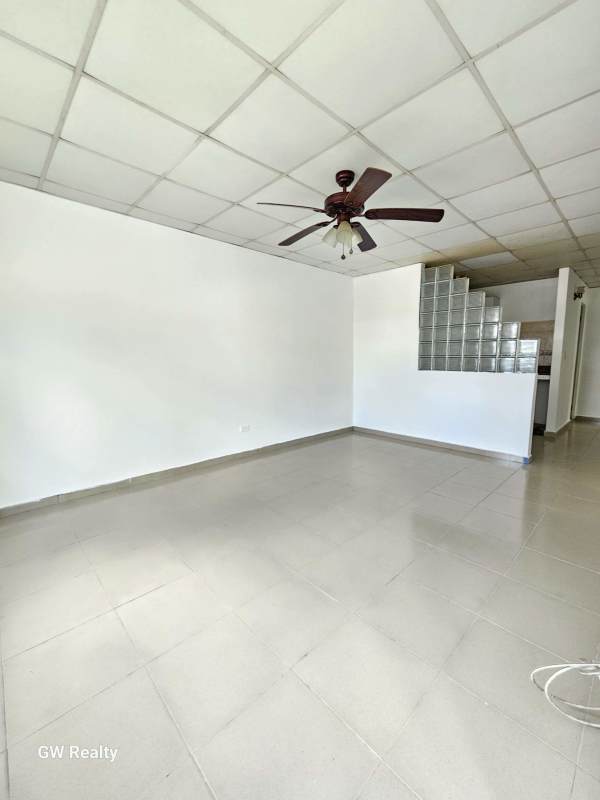 Minimalist unfurnished living room with tile floor ceiling fan and white walls in Praderas de San Lorenzo Panama