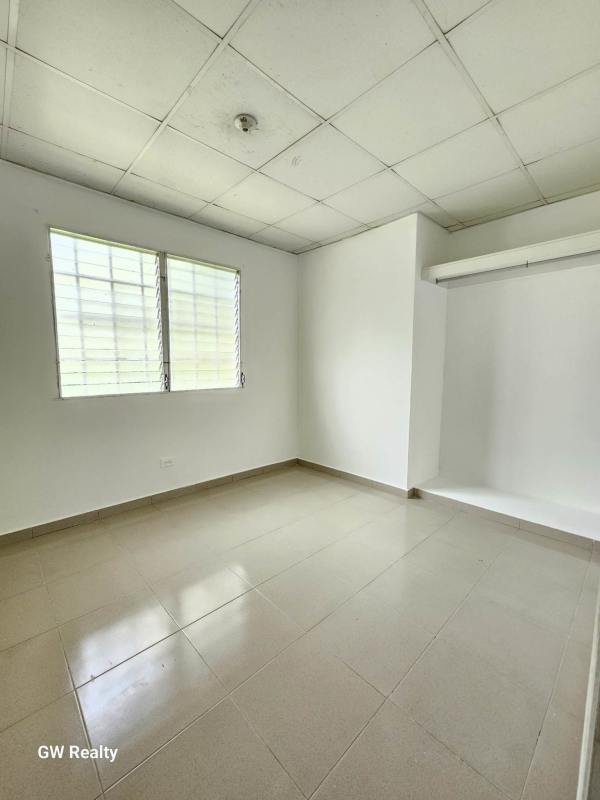 Basic bathroom with toilet sink glass shower tiled walls Chilibre Panama
