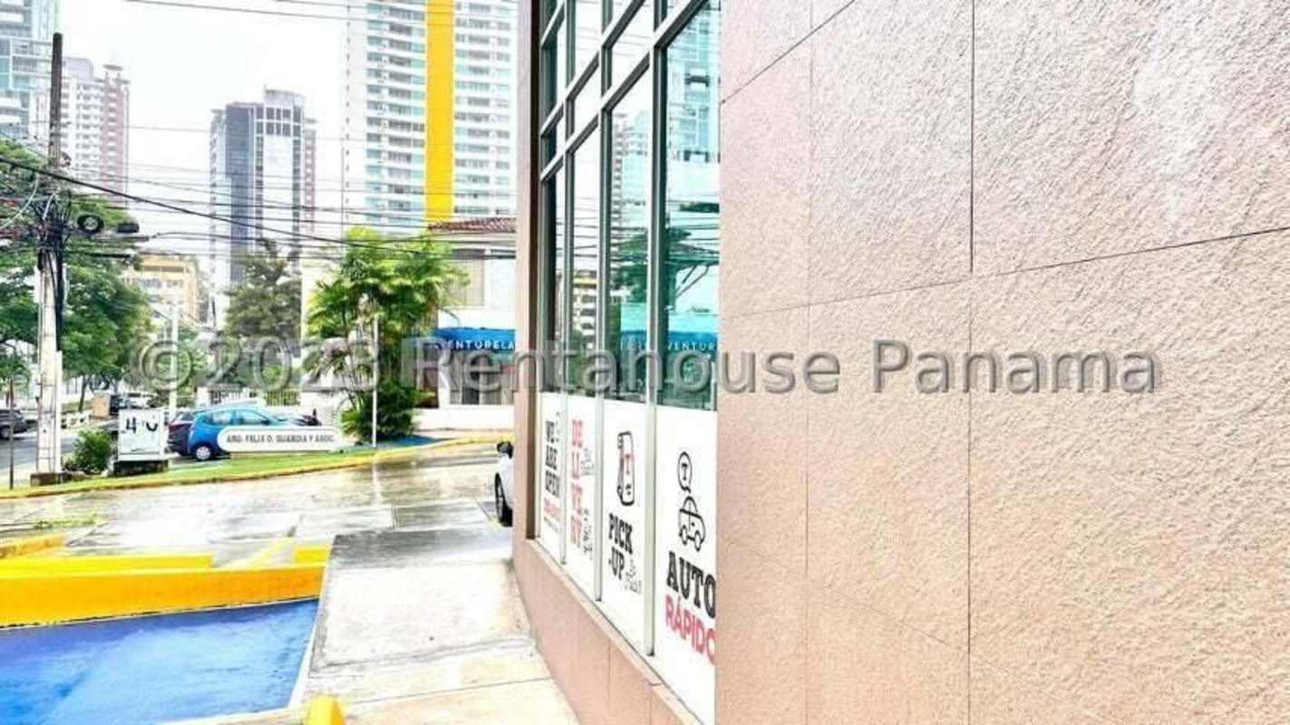 Empty commercial interior with wood-like floors, light green and orange accent walls in San Francisco Commercial Plaza