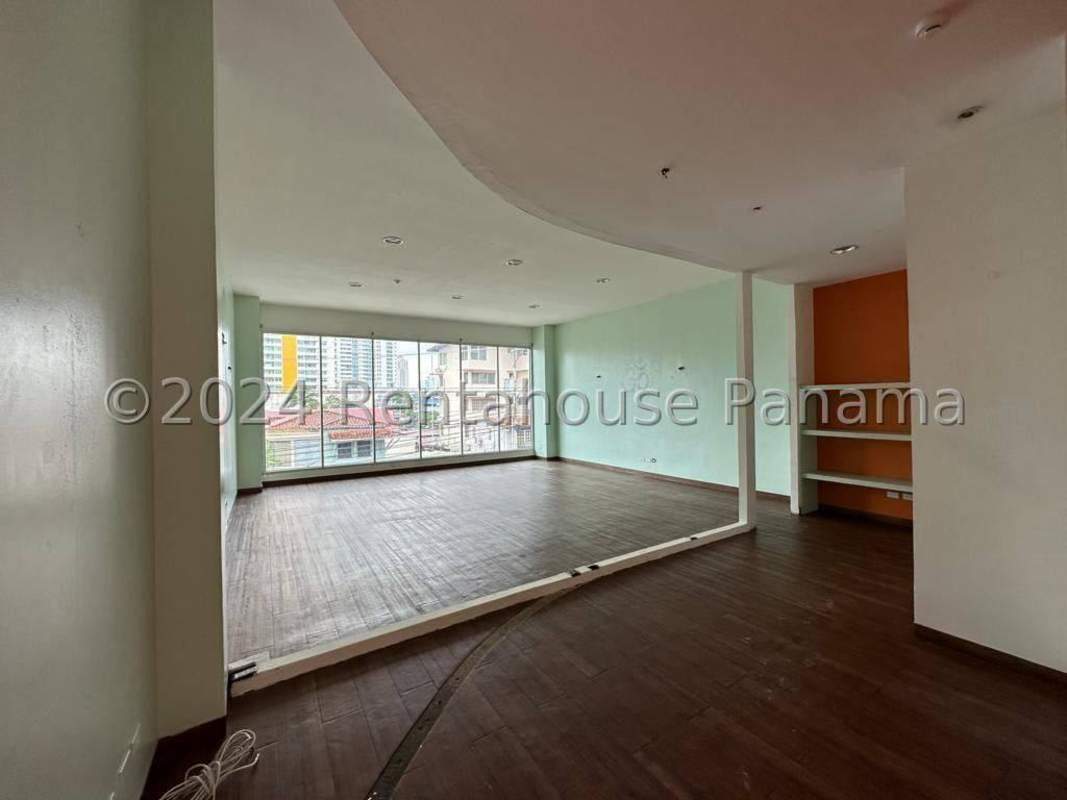 Storefront retail glass facade with sidewalk in busy Panama City commercial district