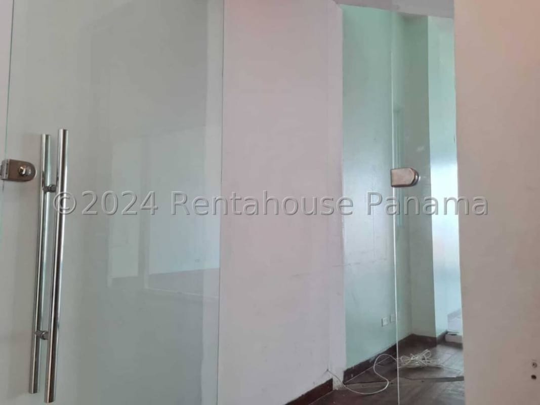Spacious modern retail or office interior with glass door and white walls in Panama City