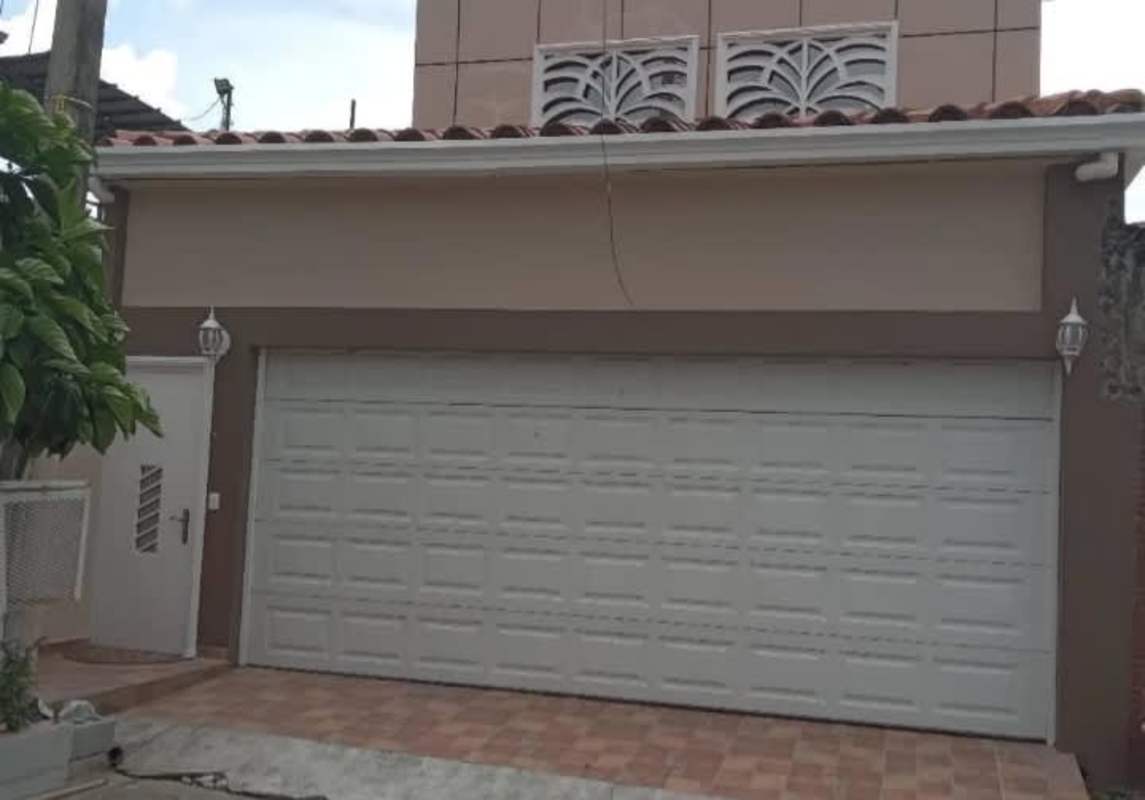 Living room with tile floors, sofas, TV, AC units in furnished Betania Panama rental house