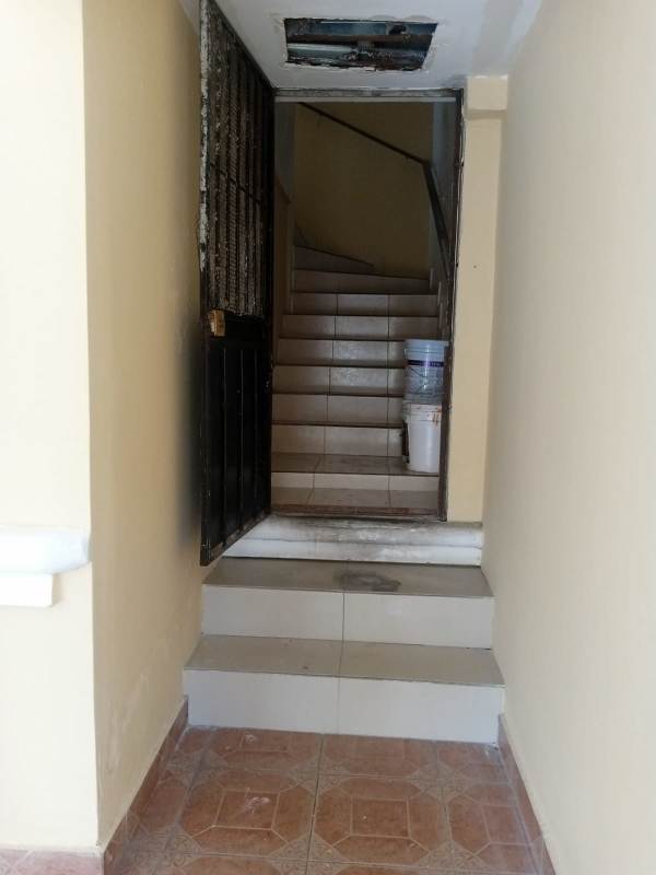 Interior stairwell with metal security door and tile stairs at Quintas de Cerro Viento duplex rental