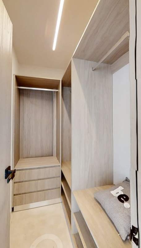 Walk-in closet with built-in wood shelving in condo suite Generation Tower Panama