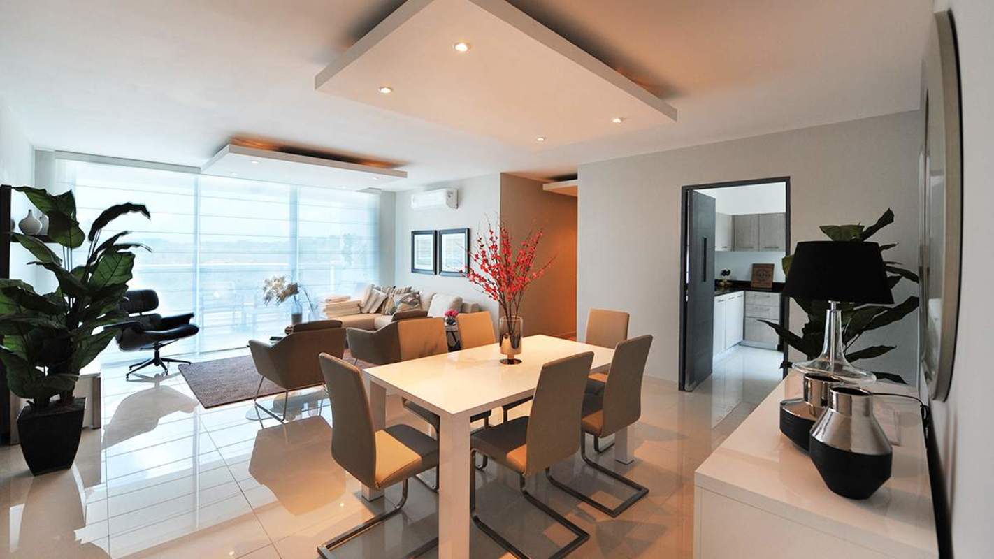 Modern open-plan living and dining space with large windows at PH Villa de las Fuentes Panama