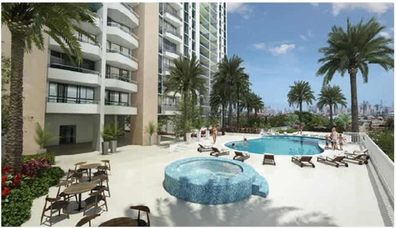 Spacious balcony with seating and glass railing overlooking cityscape at Villa de las Fuentes
