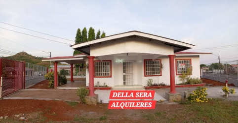 Single-family home with gated driveway, red pillars, porch, and front yard Jardines de la Riviera David Panama