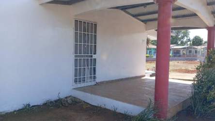 Corner lot fenced single-story house with red roof Jardines de la Riviera David Panama