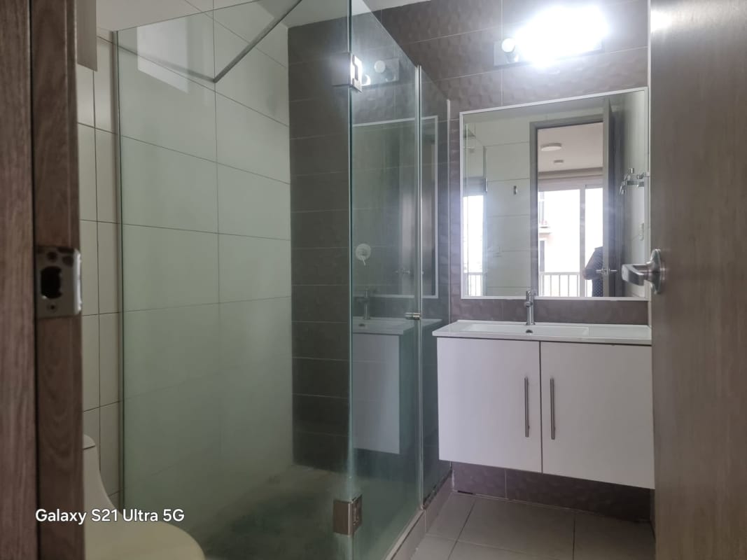 Bathroom in Torres de Versalles with glass shower enclosure and vanity