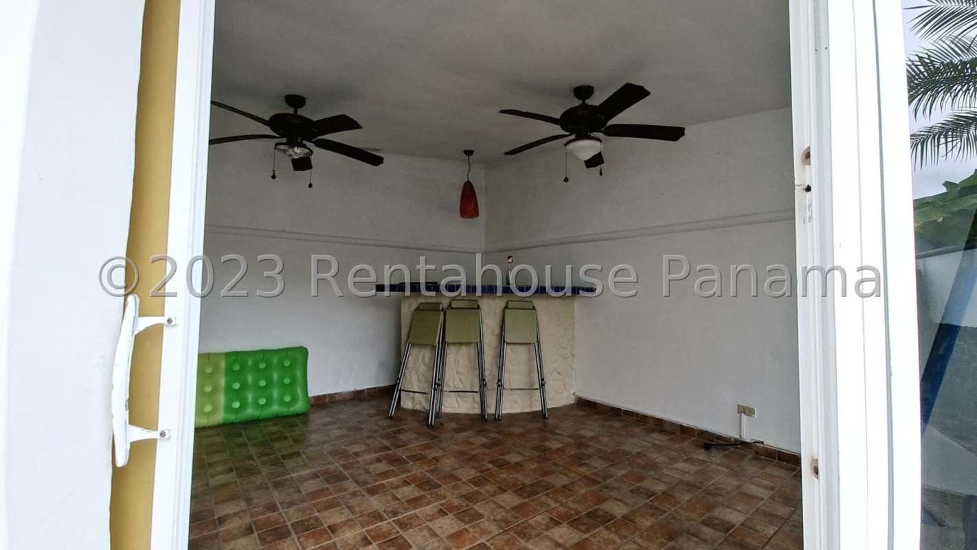 Large covered patio area with ceiling fans and view to private swimming pool in Terrazas Brisas del Golf