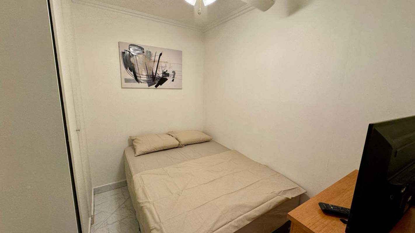 Living and dining area with large window city view PH Posada del Rey Punta Paitilla Panama