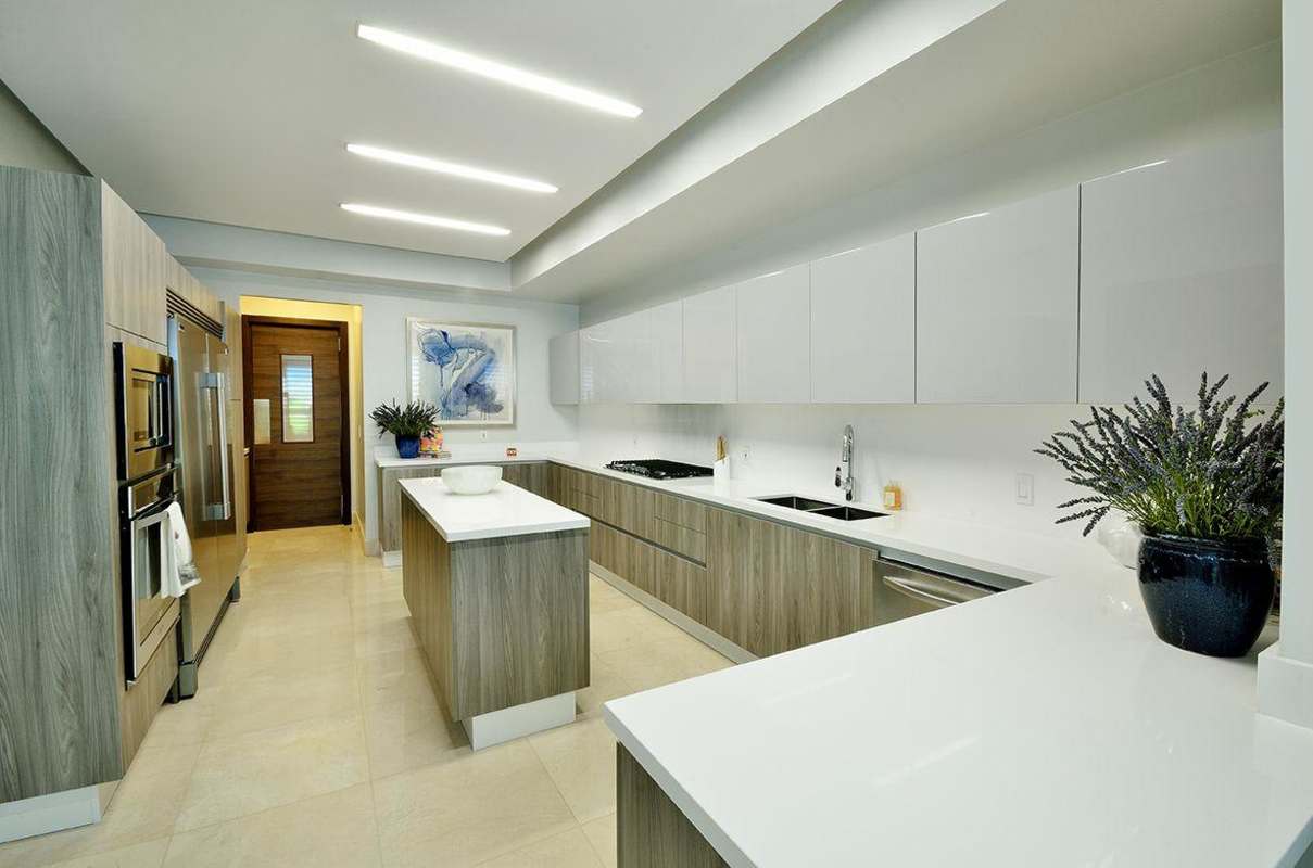High-end modern kitchen with island, double oven, and elegant cabinetry in GreenGarden Santa Maria