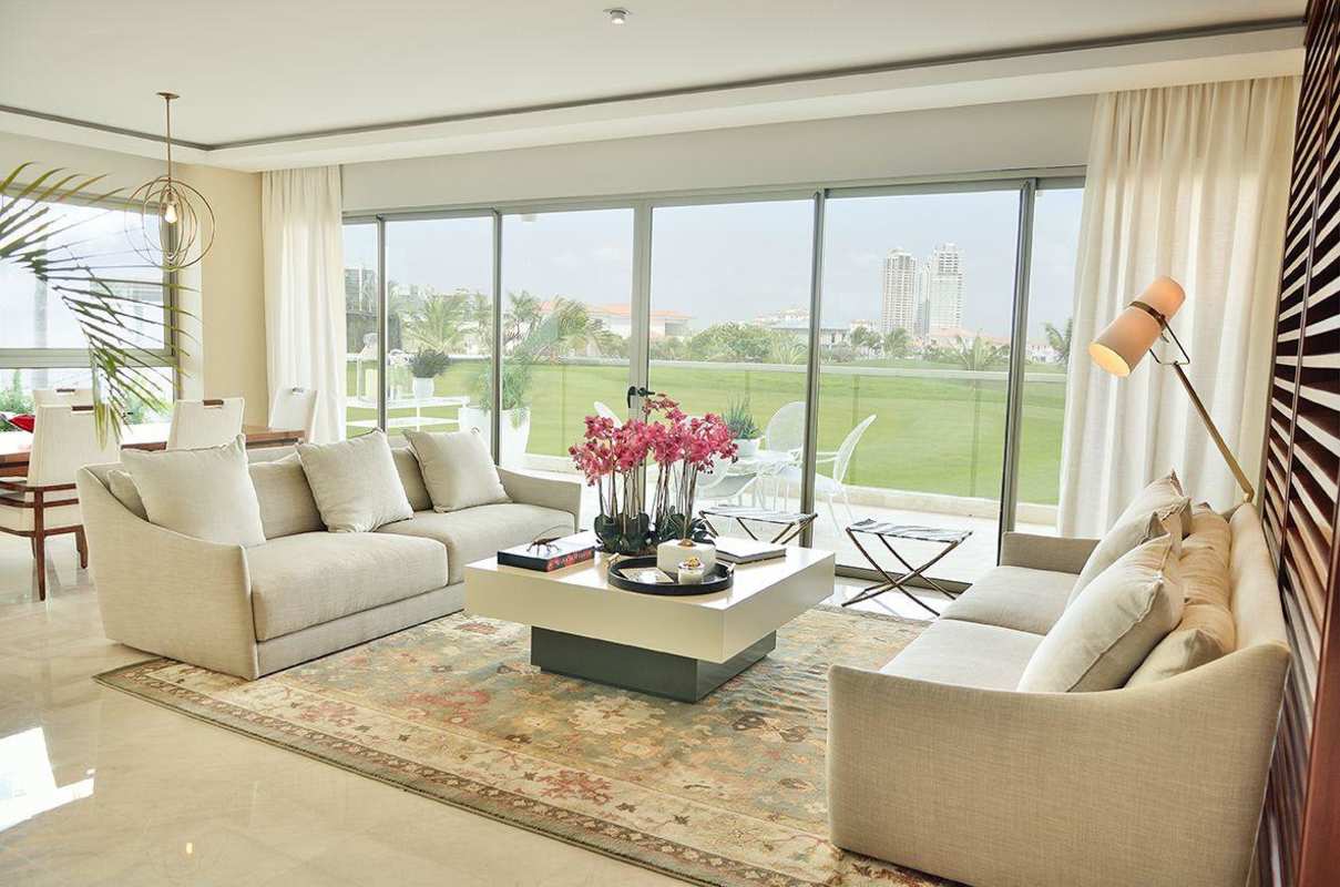 Elegant living room with golf views and sliding doors at GreenGarden Santa Maria Panama