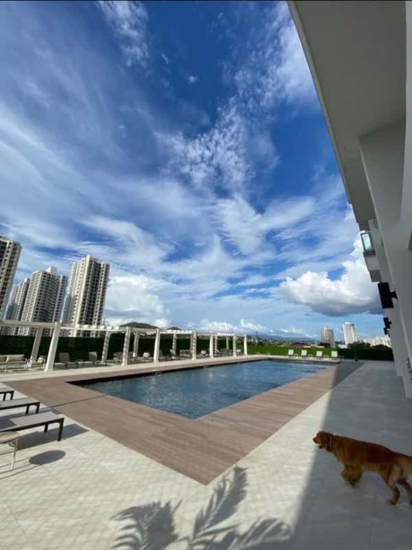 Community swimming pool with pergolas and lounge chairs at PH Condado Towers in Condado del Rey Panama