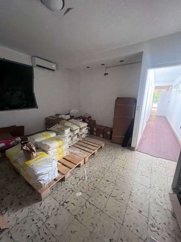 Long hallway with multiple doors white tile floor commercial space Panama