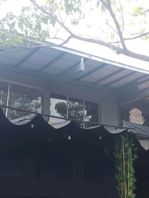 Modern mixed-use commercial building with large glass windows El Cangrejo Panama