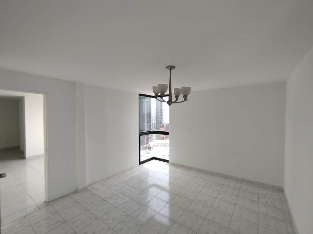 Apartment kitchen with ceramic tile backsplash, wooden cabinets and bright window in PH Costa Azul Bella Vista Panama City