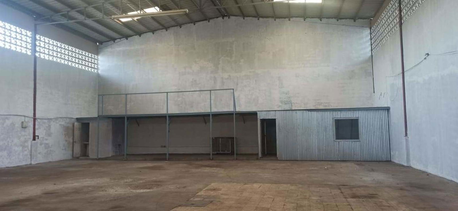 Empty warehouse with metal roof, steel trusses, skylights Pueblo Nuevo Panama