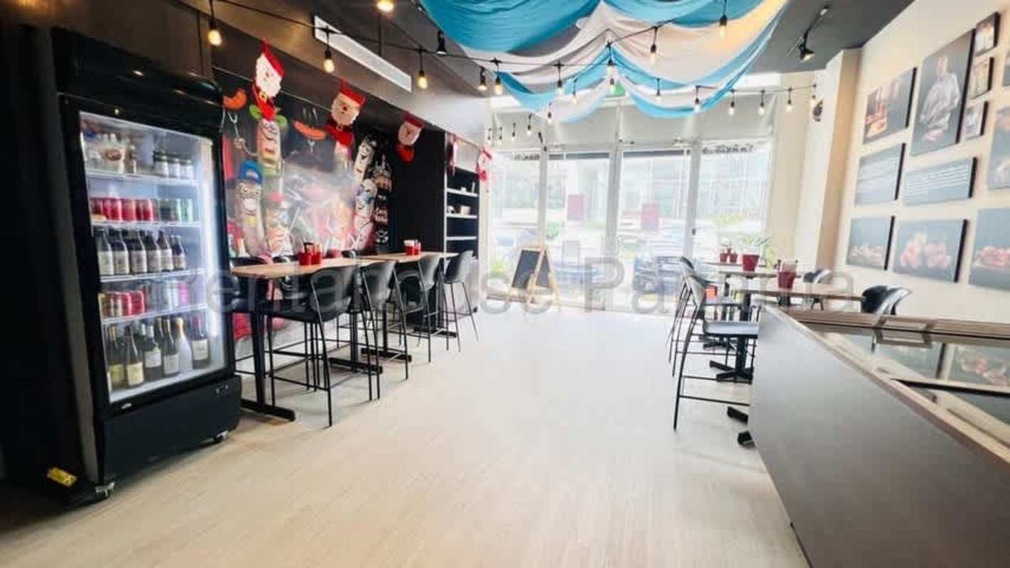 Cafe-style restaurant space with beverage display, casual seating, and festive decor in San Francisco Panama