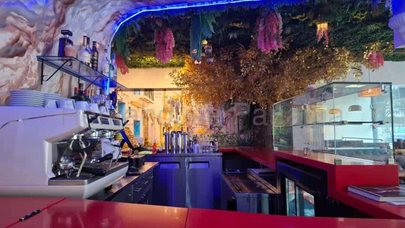 Modern bar with LED lighting, shelving and decor inside restaurant Bella Vista