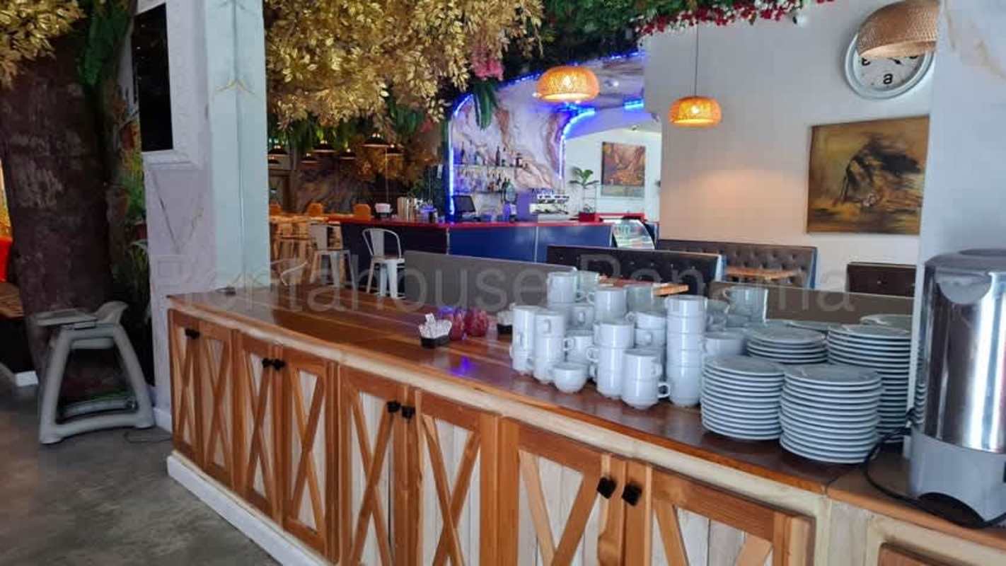 Outdoor patio with seating mural wall and greenery on Calle 50 Panama City