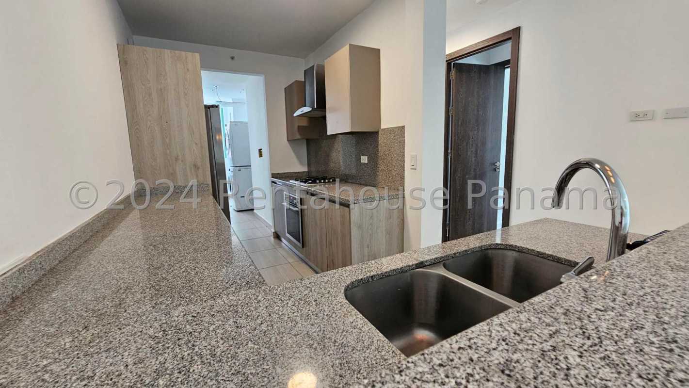 Modern kitchen with granite countertops, gas stove, built-in cabinets in PH Asia Costa del Este Panama City