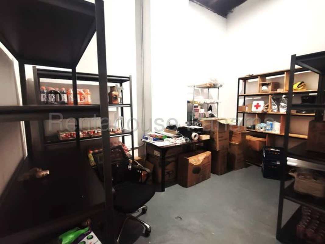 Warehouse style storage area with shelves boxes and industrial lighting Plaza El Cangrejo