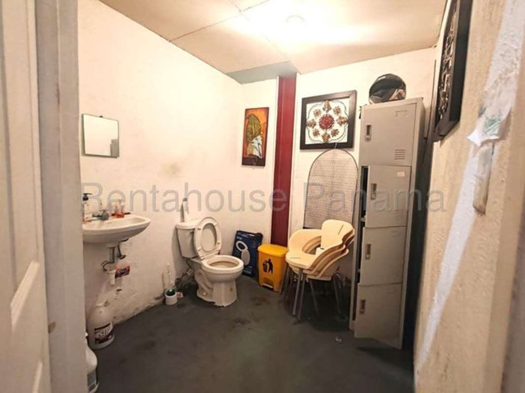 Commercial bathroom with locker, cleaning supplies and chair Plaza El Cangrejo Panama
